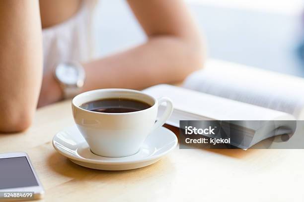 Woman Reading Book And Drinking Coffee At Cafe Stock Photo - Download Image Now - Book, Coffee - Drink, Drinking