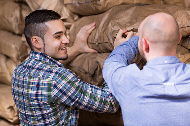 istock Workers carrying bags of cement 524885100