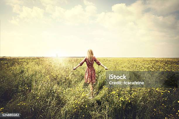 Dreamy Woman Walking In Nature Towards The Sun Stock Photo - Download Image Now - Women, One Woman Only, Nature