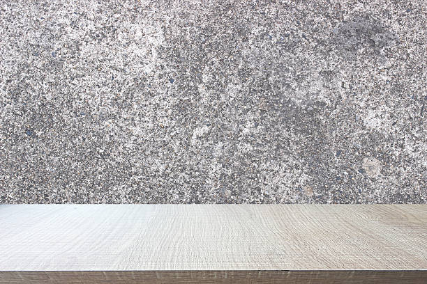 istock Top of wood table on old concrete wall background. 524885950