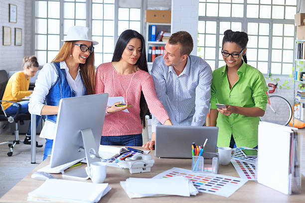 istock Group of young designers discussing new project at office. 524889946