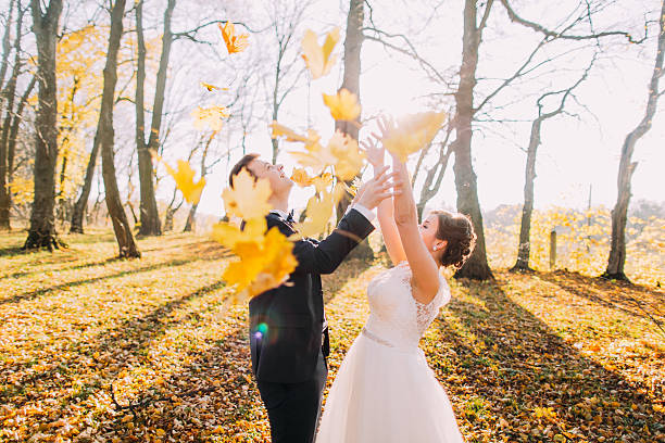 istock The married couple throw up maple leaves in the autumn 524891490