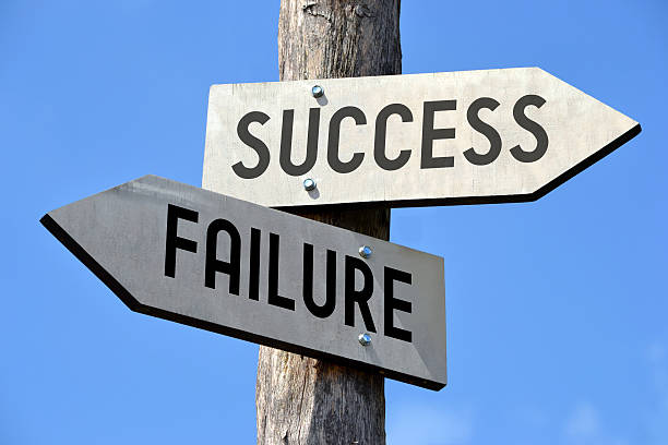 Success and failure signpost stock photo