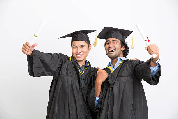 istock Cheerful young two male graduates 524894838