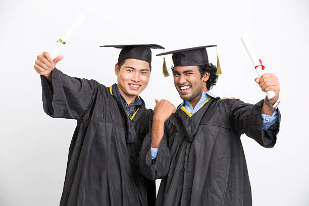 istock Cheerful young two male graduates 524895060