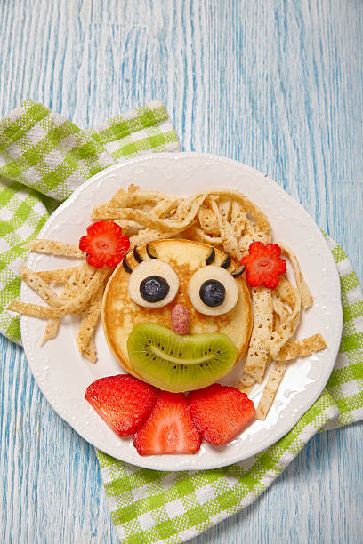 istock Funny pancake face with fruits and berries 524895110