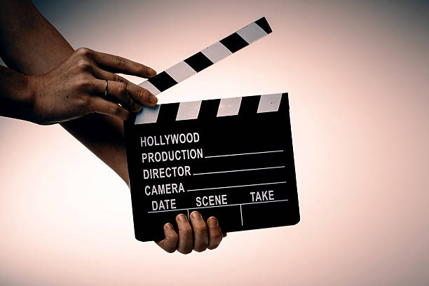 istock Movie flapper in woman´s hands on white background 524895244