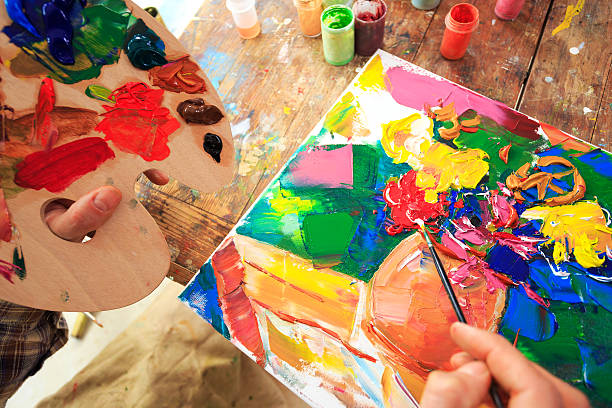 istock Painting, hand holding a palette and brush 524896004