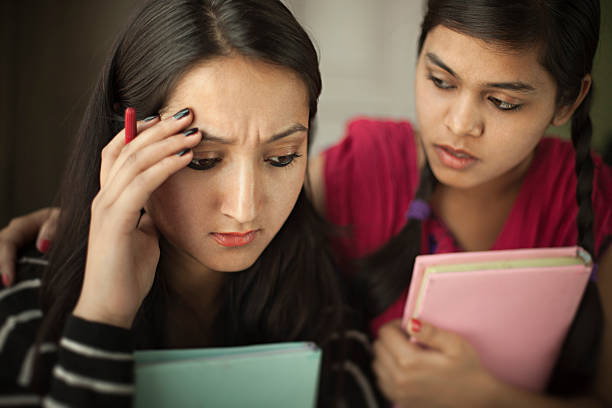 istock Late teen student consoling to a depressed friend while studying. 524896096