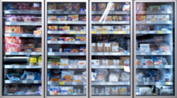 cooling shelves freezer in supermarket - blurred out of focus cooling shelves freezer in supermarket with different products refrigerated section supermarket photos stock pictures, royalty-free photos & images