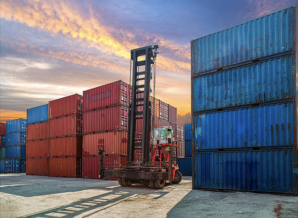 istock Forklift handling container box loading to truck in import expor 524898012