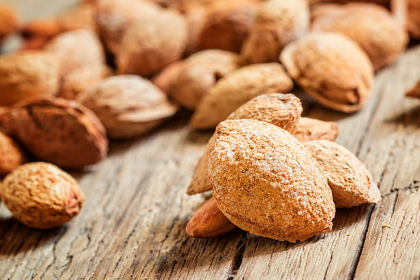 istock Salted almonds in shell on a vintage wooden background 524898878