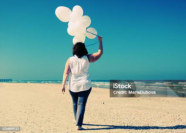 Woman Holding White Balloons Stock Photo - Download Image Now - Overweight, Women, Balloon