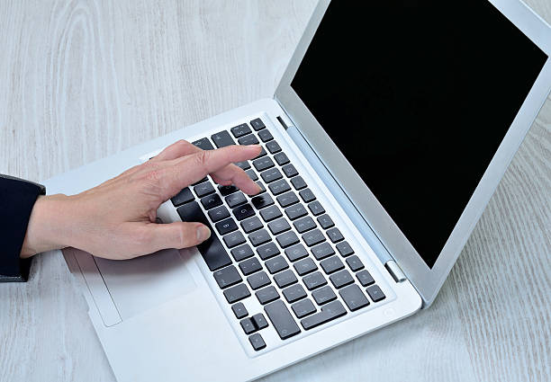 istock woman hand tasting at laptop 524899434