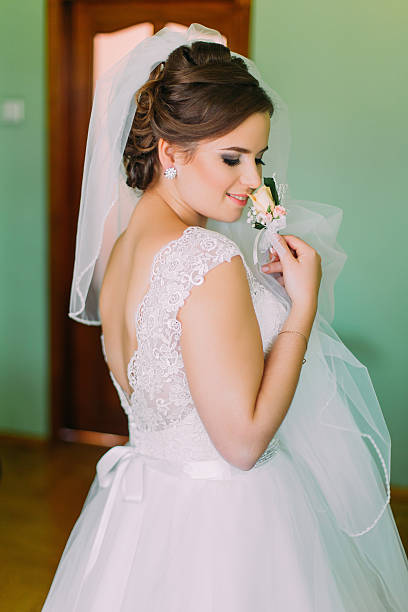 istock Beautiful bride in  lace wedding dress standing with his back 524900464