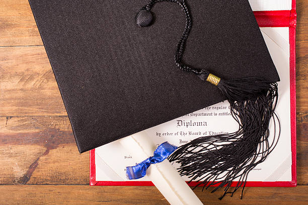 istock Graduation!  Cap, motarboard and tassel with dilplomas on table. Education. 524900728