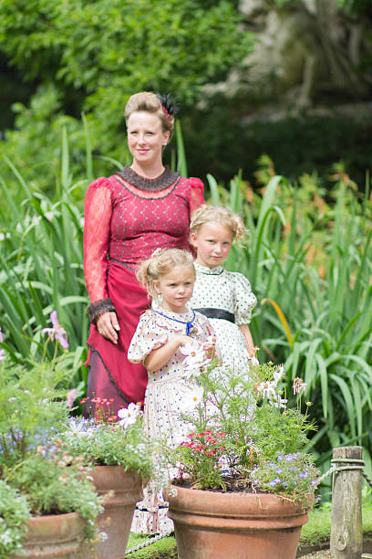 istock mother and daughters in edwardian dress 524901536