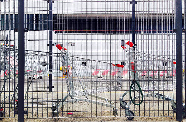 istock Shopping carts behind a metal fence 524902479