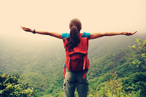 istock cheering woman hiker enjoy the view on mountain peak 524902606