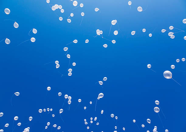 istock White balloons in the blue sky 524902735