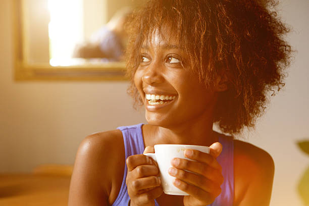 istock Smiling young african american woman with coffee cup 524903104