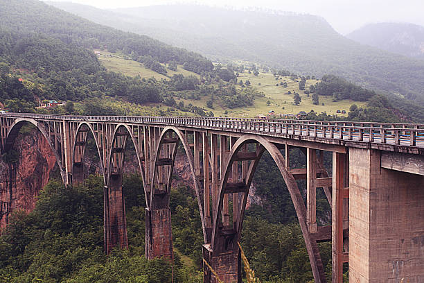 istock bridge in the mountains fog clouds rain 524903151