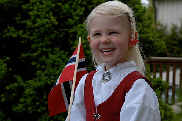 Little girl on Norwegian constitution day Laughing little girl with flag on Norwegain constitution day. Dressed in national costume. number 17 stock pictures, royalty-free photos & images