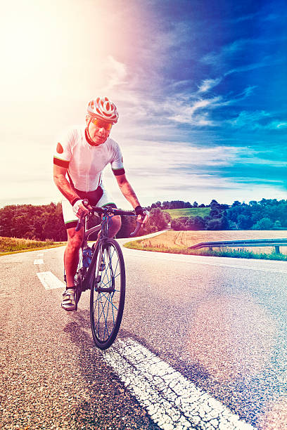 istock Professional bike rider rides bicycle up hill 524903410
