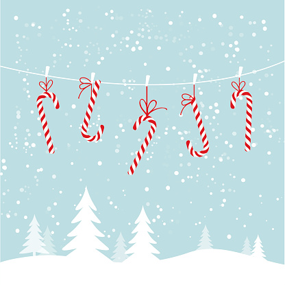 Hanging candy canes in snowy winter scene