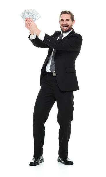 istock Smiling businessman holding money 524903868
