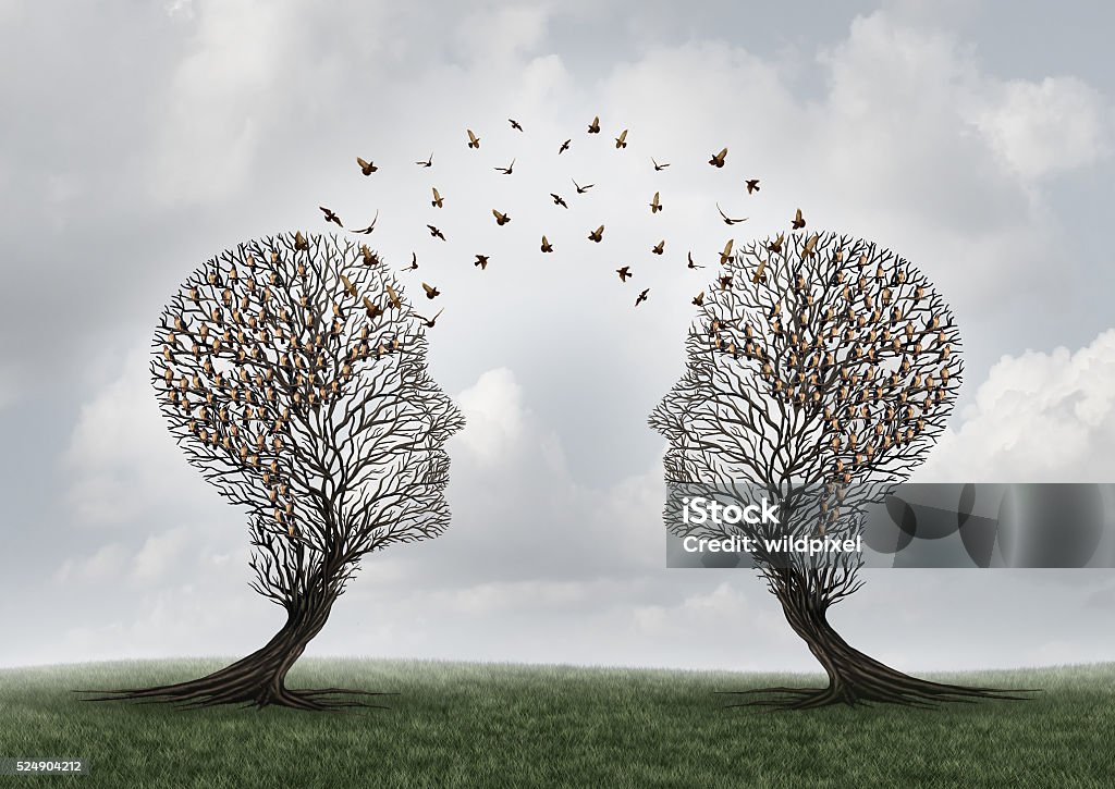 Concept Of Communication Concept of communication and communicating a message between two head shaped trees with birds perched and flying to each other as a metaphor for teamwork and business or personal relationship with 3D illustration elements. Communication Stock Photo