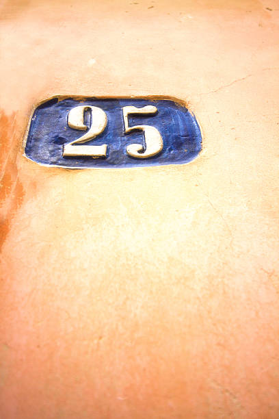 istock Blue Ceramic Number 25 Address Tile On Pretty Orange Wall 524904316