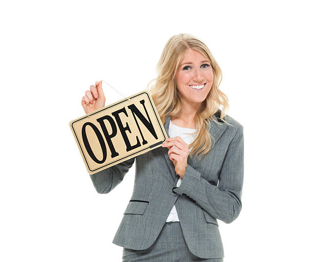 istock Cheerful businesswoman holding open sign 524904424