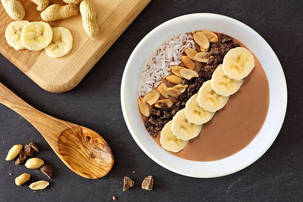 chocolate, peanut-butter, banana, smoothie bowl downward scene on slate - yoghurt chocolate bowl bildbanksfoton och bilder