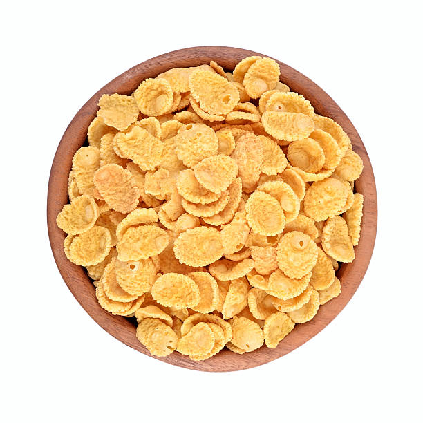 istock Cornflakes in a wooden bowl on a white background 524906801