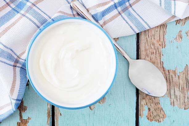 istock Greek yogurt, downward view with cloth and spoon 524906948