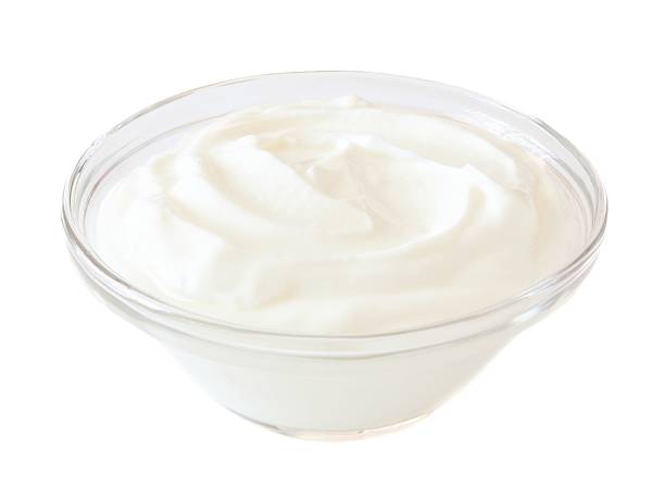Greek yogurt in transparent bowl isolated on white Greek yogurt in a transparent bowl isolated on a white background greek yogurt photos stock pictures, royalty-free photos & images