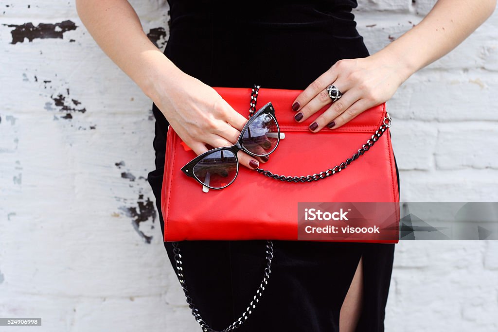 Fashionable woman with  stylish red clutch and sunglasses Fashionable woman with  stylish red clutch , accessories, sunglasses white background Purse Stock Photo