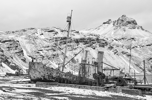 A ship washed ashore near Teriberka, Barents Sea bay. Kola Peninsula winter landscape. Russia