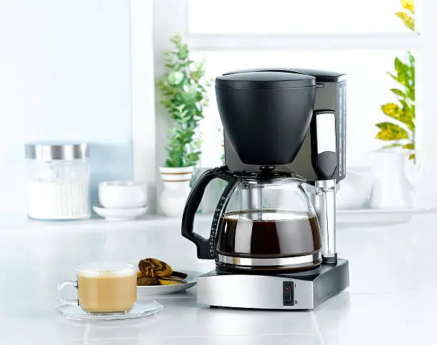 Photo of Coffee blender and boiler machine in kitchen interior