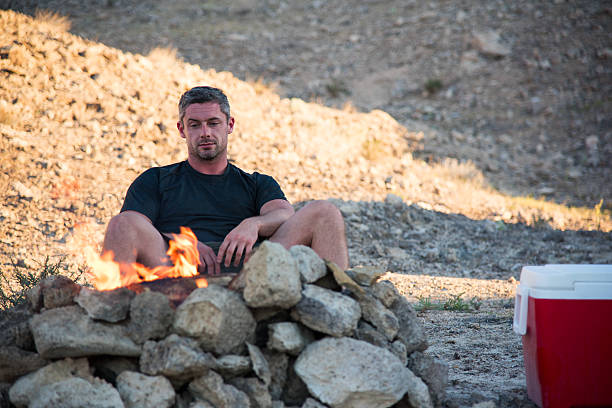 istock Man Sitting by the Campfire 524908750