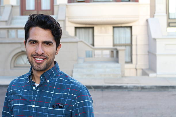 young man smiling with urban background - iraanse cultuur stockfoto's en -beelden