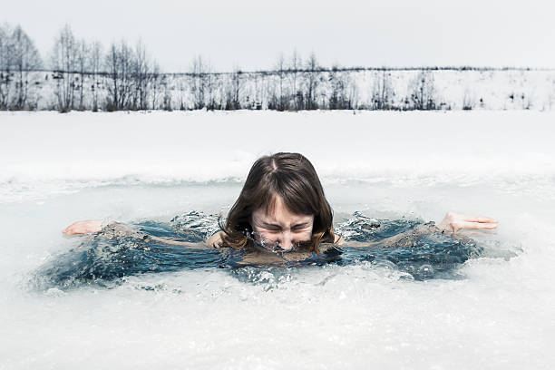 Ice hole swimming Young lady bathing in the ice hole cold plunge stock pictures, royalty-free photos & images