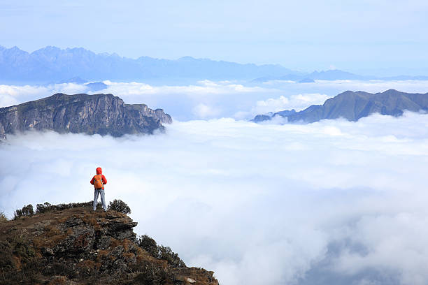 istock young woman backpacker hiking at mountain peak 524910384