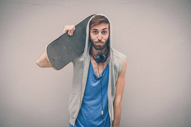 istock young hipster gay man with skate 524921313