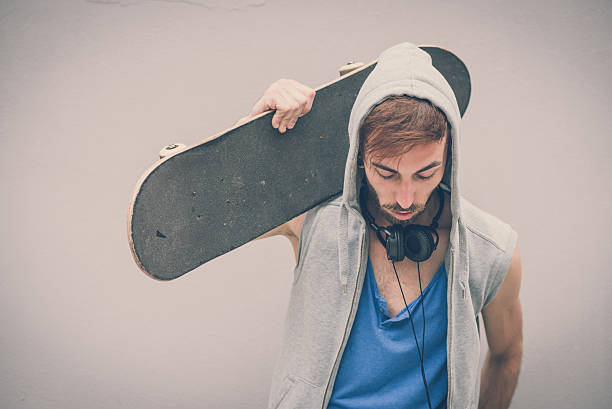 istock young hipster gay man with skate 524921315