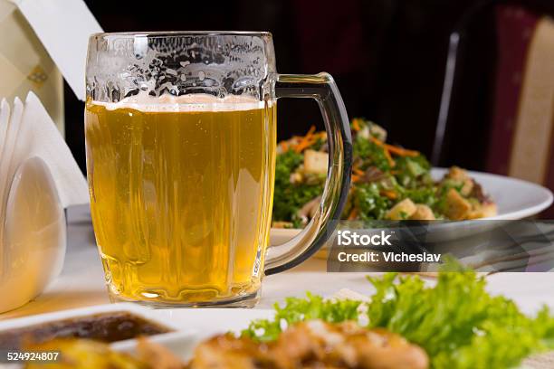Mug Beer On Table Amongst Plates Of Food Stock Photo - Download Image Now - Affectionate, Beer - Alcohol, Braided