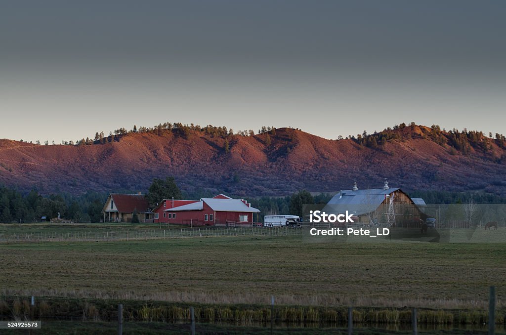 mountain barn dawn Pagosa ranch with mountain lit with dawn light. Landscape - Scenery Stock Photo