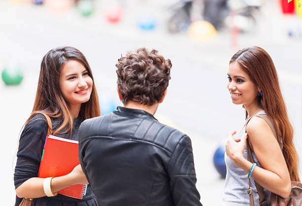 Young man's dilemma A young man is having a dilemma. He has to choose between two young sensual women. menage trois stock pictures, royalty-free photos & images