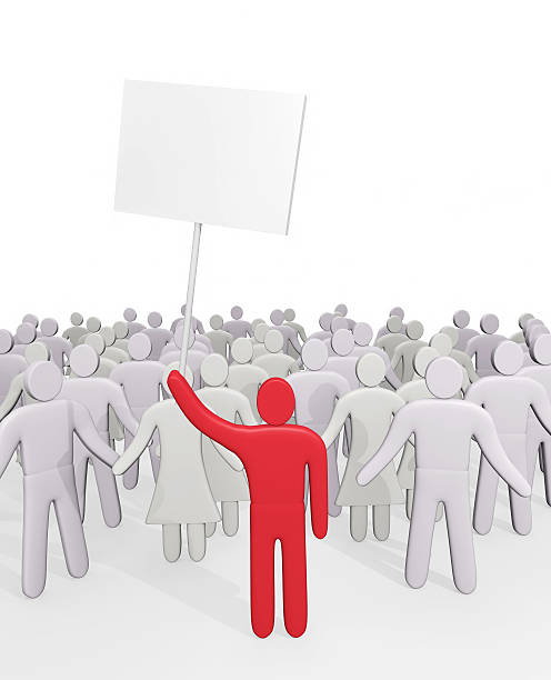 istock Man with poster stands before crowd of people 524927453